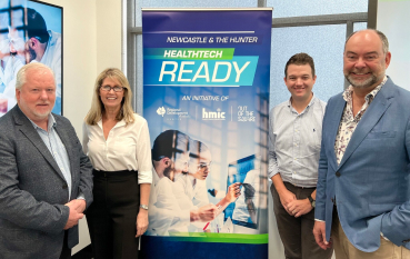 4 people standing beside banner for HealthTech Ready